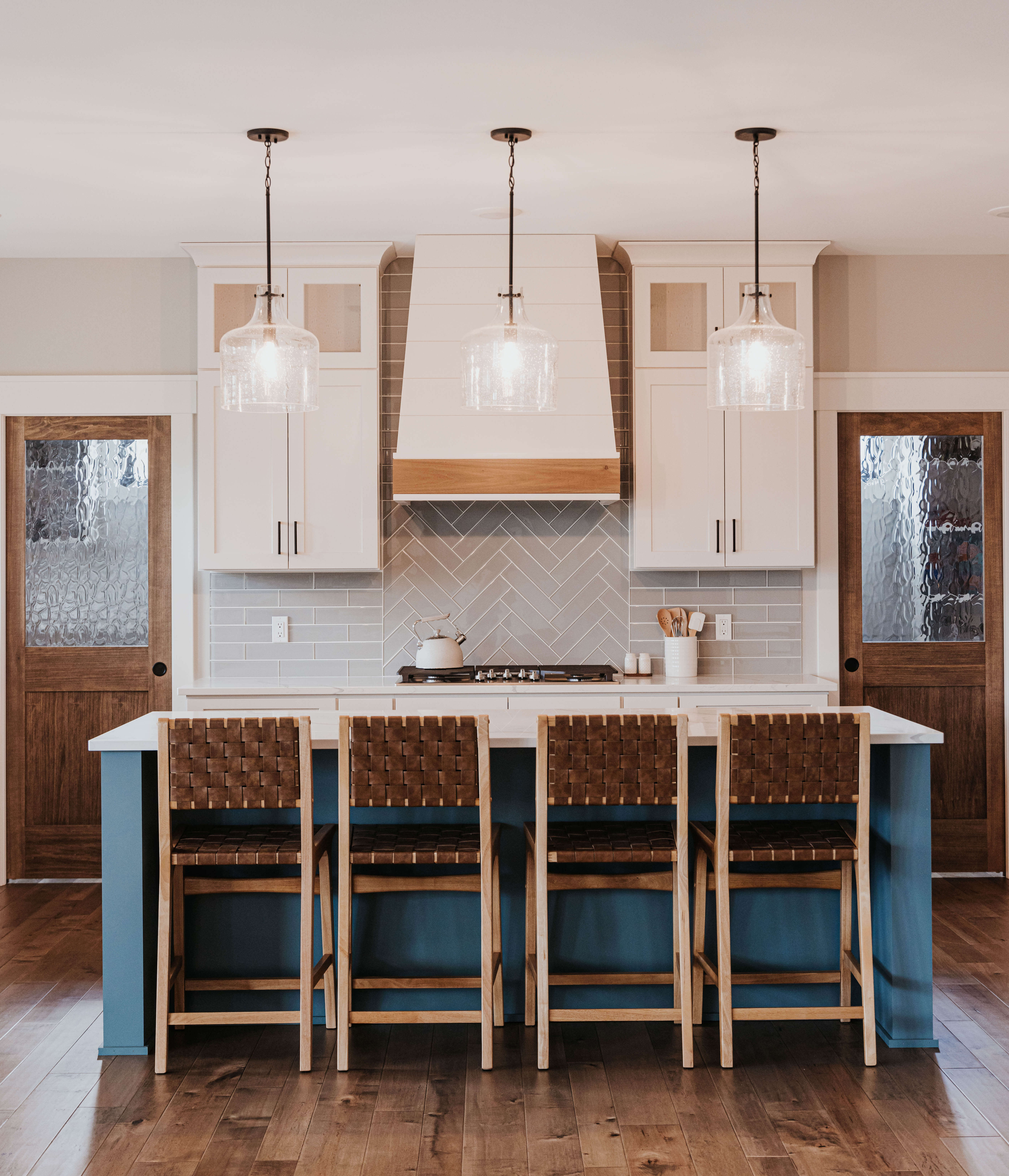 A beautiful kitchen with a custom blue painted kitchen island from Dura Supreme Cabinetry.