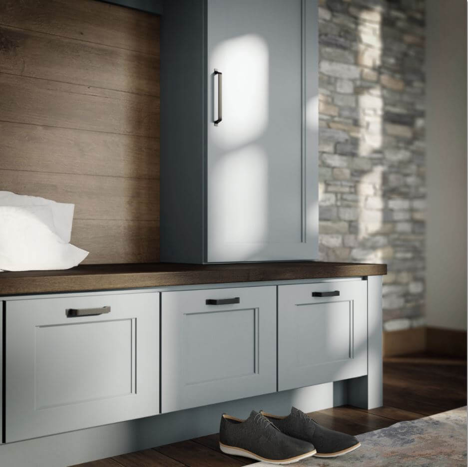 A mudroom boot bench with a soft gray paint that is both trendy and a long-term classic color for cabinets.