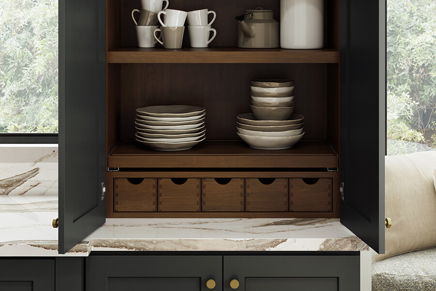 Frameless kitchen cabinet larder with organized storage for dishware and pantry items.