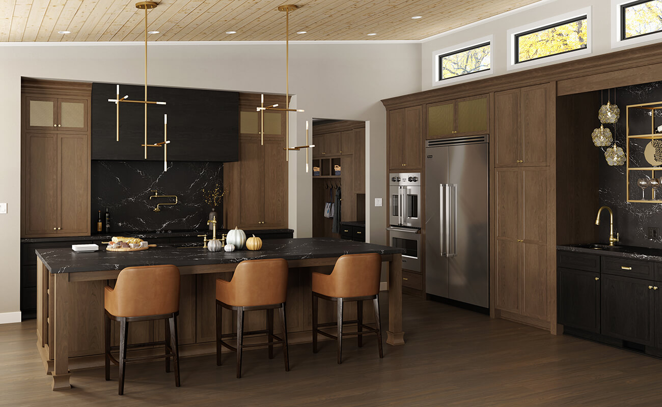 A modern kitchen with traditionally framed cabinets in a mix of brown stained wood and black stained wood.