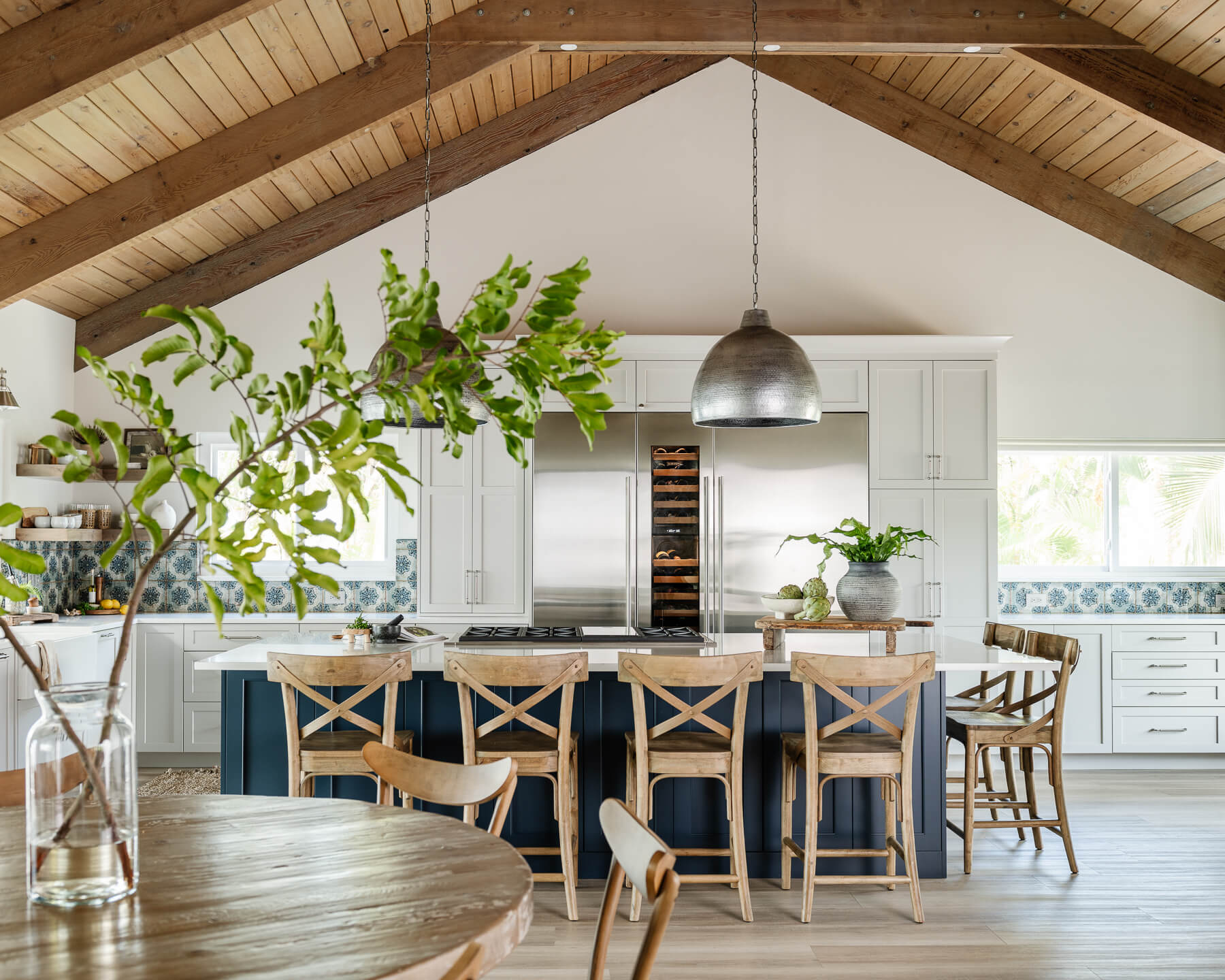 A modern farmhouse kitchen remodel with white and navy blue painted cabinets.