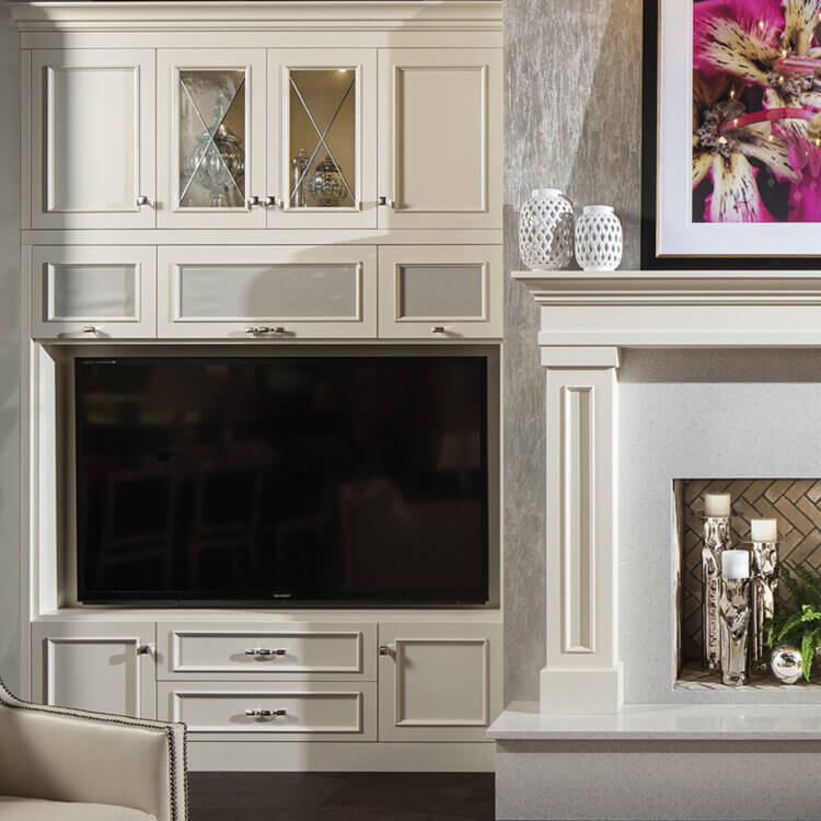 A built-in media wall and entertainment center next to a matching fireplace mantel.
