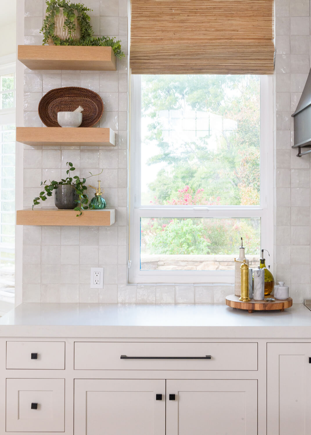 A kitchen remodel with a coastal style featuring beachy blinds and floating shelves for displaying decor.