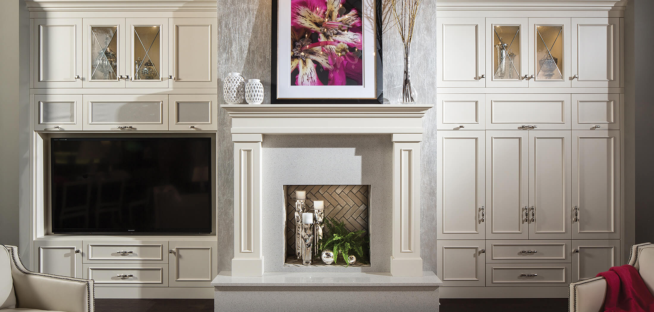 A full wall of entertainment center cabinets built in around the fireplace.