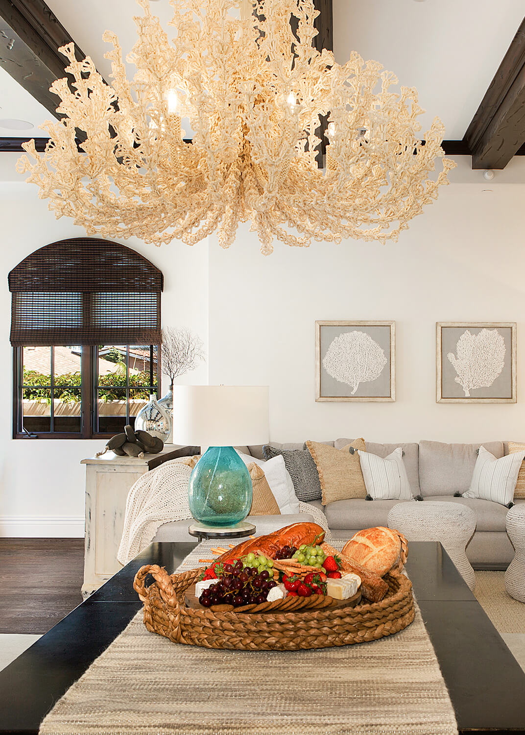Coastal style chandelier over a table that looks like coral.