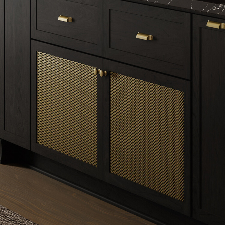 A close up of black stained wood cabinets with brushed brass wire mesh inserts in the cabinet doors.