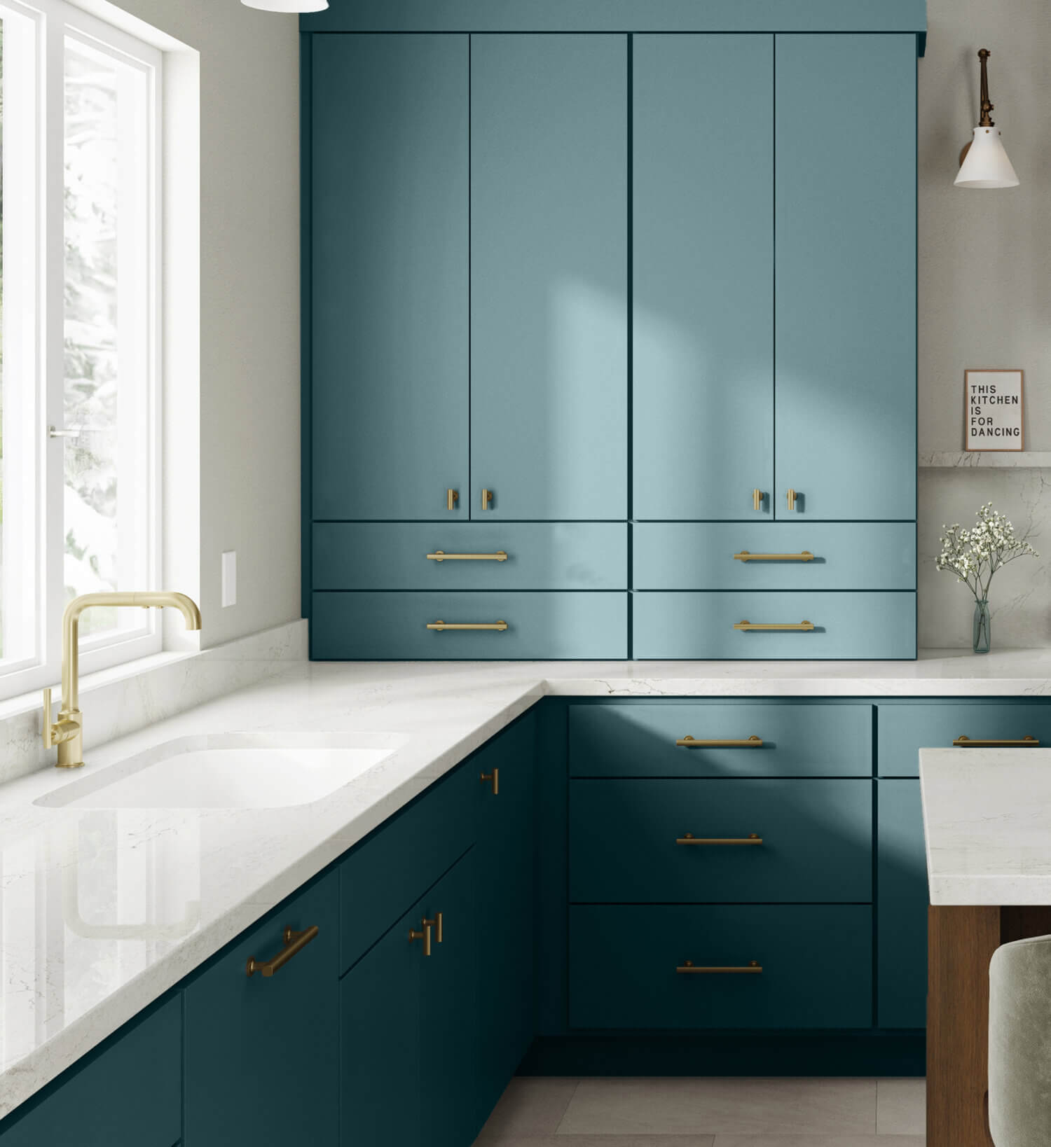 A modern, contemporary kitchen design with colorful ocean blue/teal matte cabinets with a simple slab door style and white countertops.