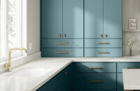 A modern, contemporary kitchen design with colorful ocean blue/teal matte cabinets with a simple slab door style and white countertops.