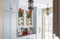 A festive butler's pantry design with Christmas decorations a light gray custom cabinets from Dura Supreme.
