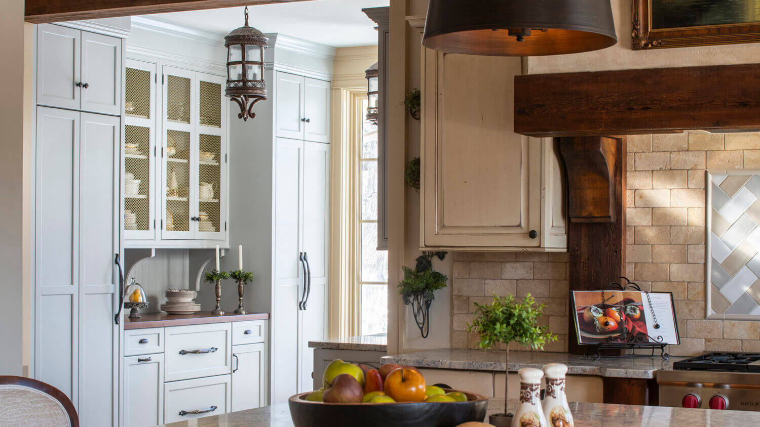 A traditional farmhouse kitchen with an old English styled butler's pantry side kitchen.