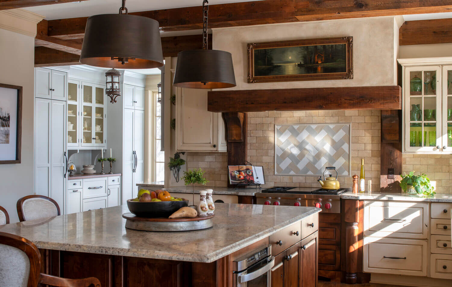 A traditional English styled kitchen with a messy kitchen to the side with a modern English style and light gray painted cabinets.
