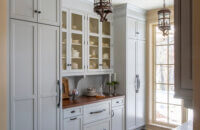 A new Old English style pantry with inset cabinet doors and a light gray painted finish from Dura Supreme Cabinetry.