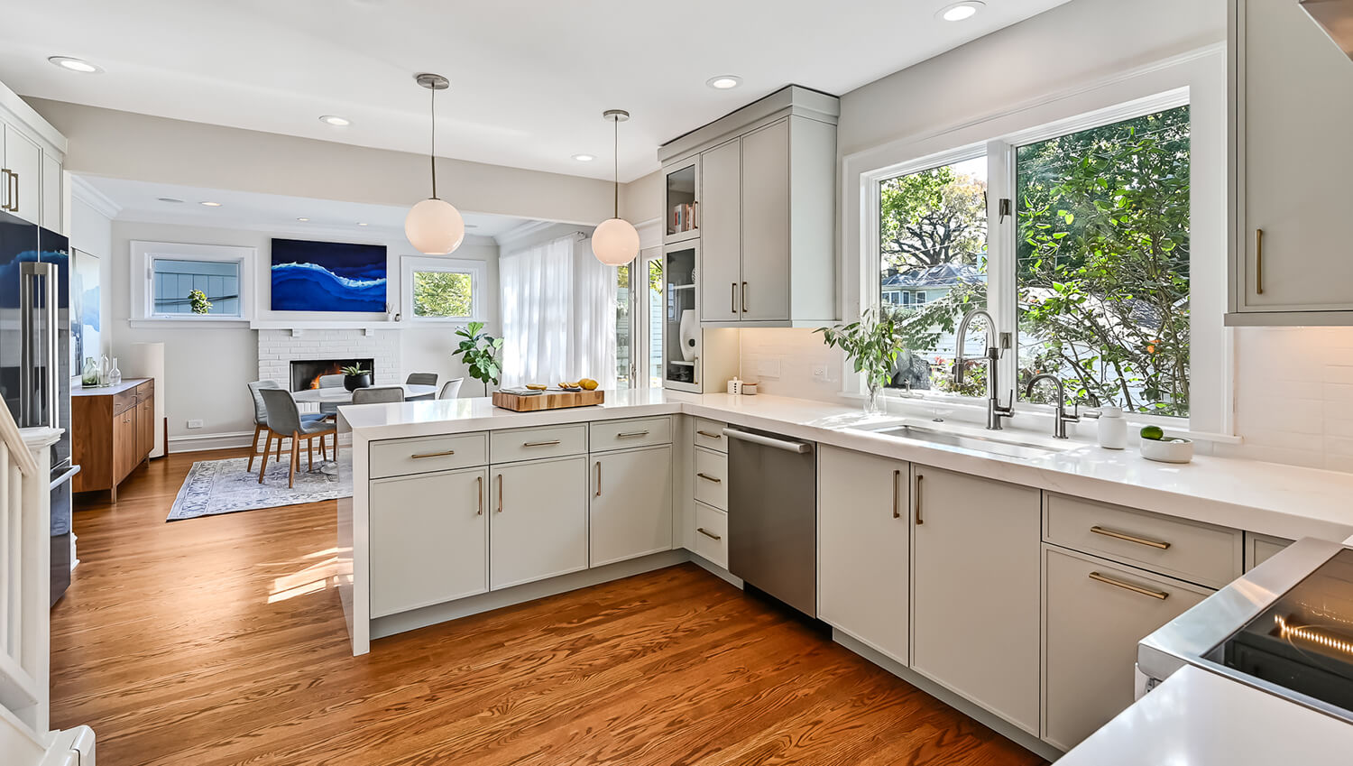 A skinny shaker kitchen with an elegant peninsula with a waterfall countertop.