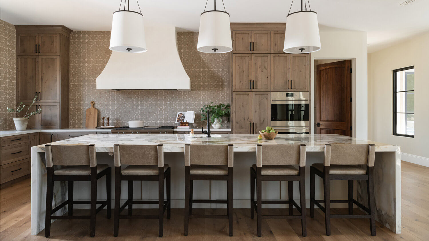 With an emphasis on comfort, heritage-inspired details, and lived-in textures, this family home is a Mediterranean oasis. This stunning Mediterranean inspired home features Dura Supreme’s Hudson shaker door style in a combination of the “Cashew” stain on Knotty Alder
