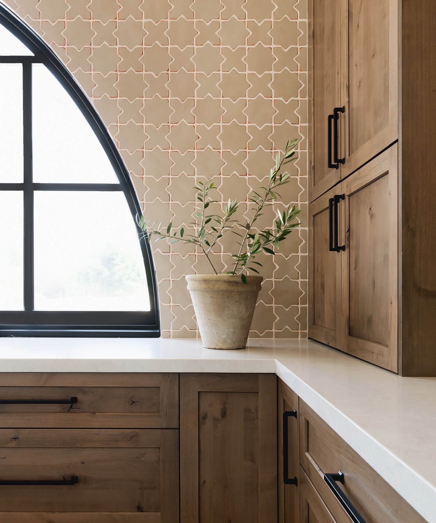 With an emphasis on comfort, heritage-inspired details, and lived-in textures, this family home is a Mediterranean oasis. This stunning Mediterranean inspired home features Dura Supreme’s Hudson shaker door style in a combination of the “Cashew” stain on Knotty Alder
