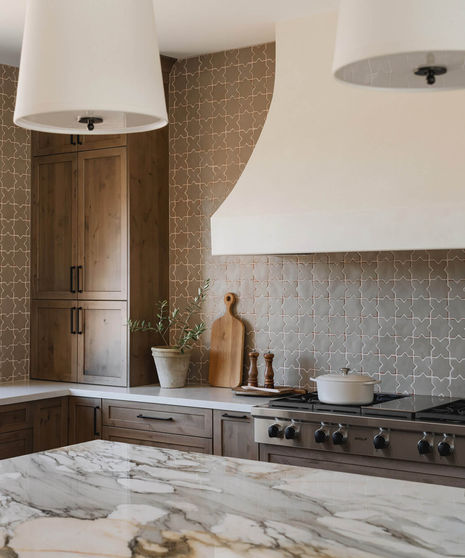 With an emphasis on comfort, heritage-inspired details, and lived-in textures, this family home is a Mediterranean oasis. This stunning Mediterranean inspired home features Dura Supreme’s Hudson shaker door style in a combination of the “Cashew” stain on Knotty Alder