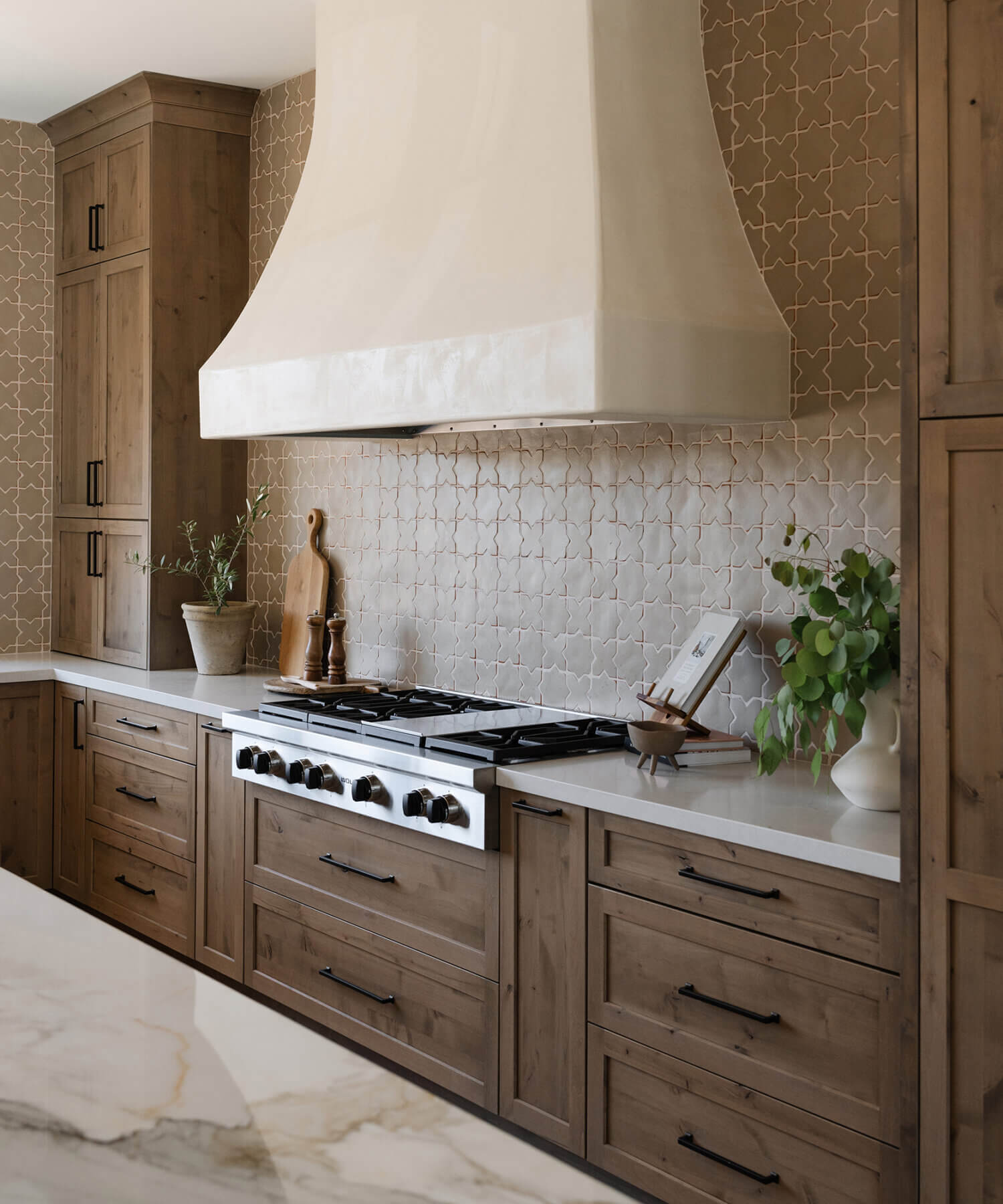 With an emphasis on comfort, heritage-inspired details, and lived-in textures, this family home is a Mediterranean oasis. This stunning Mediterranean inspired home features Dura Supreme’s Hudson shaker door style in a combination of the “Cashew” stain on Knotty Alder