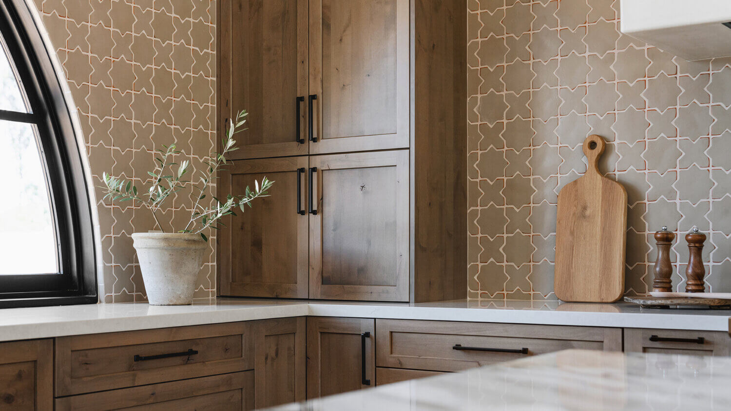 With an emphasis on comfort, heritage-inspired details, and lived-in textures, this family home is a Mediterranean oasis. This stunning Mediterranean inspired home features Dura Supreme’s Hudson shaker door style in a combination of the “Cashew” stain on Knotty Alder