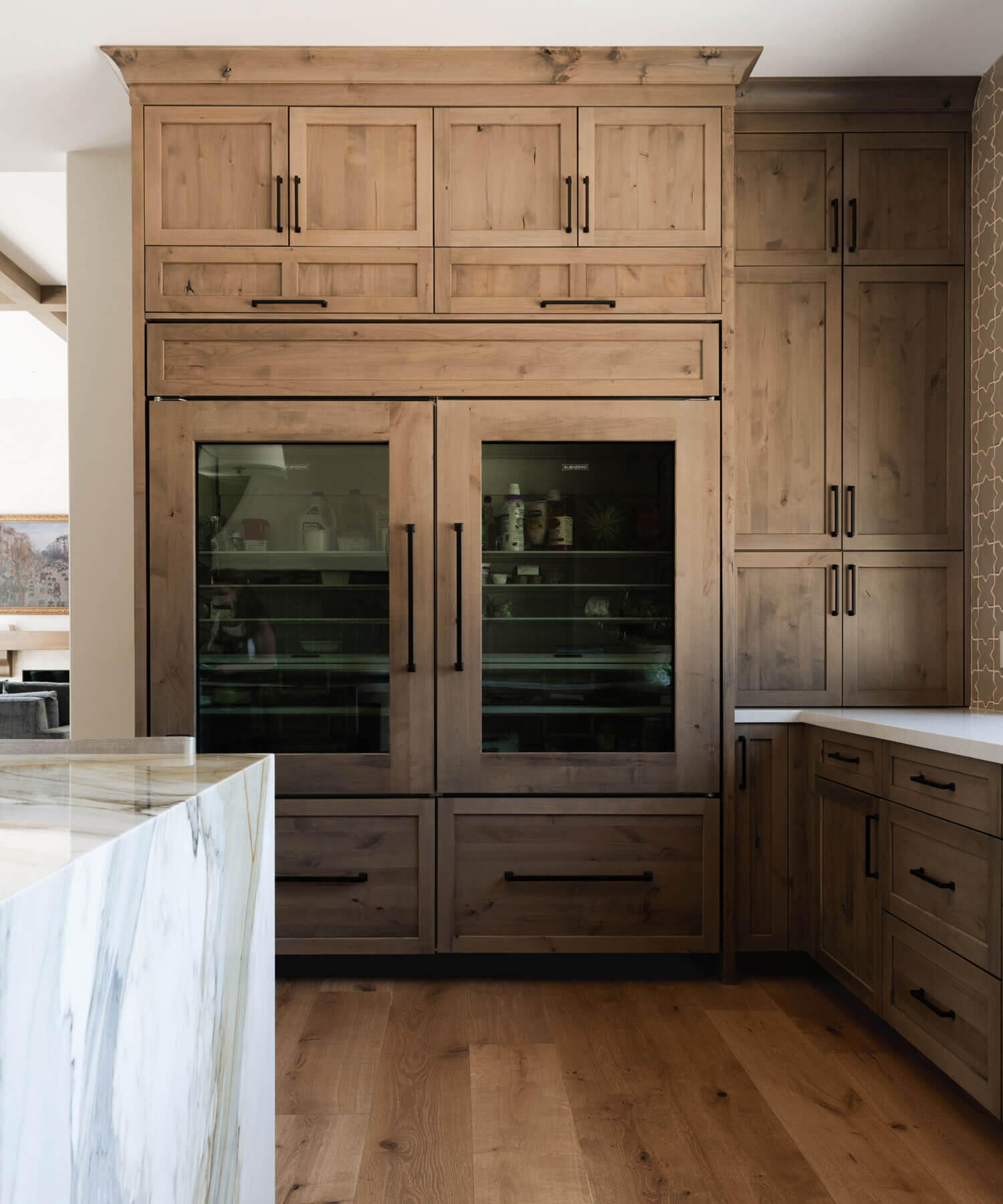 With an emphasis on comfort, heritage-inspired details, and lived-in textures, this family home is a Mediterranean oasis. This stunning Mediterranean inspired home features Dura Supreme’s Hudson shaker door style in a combination of the “Cashew” stain on Knotty Alder