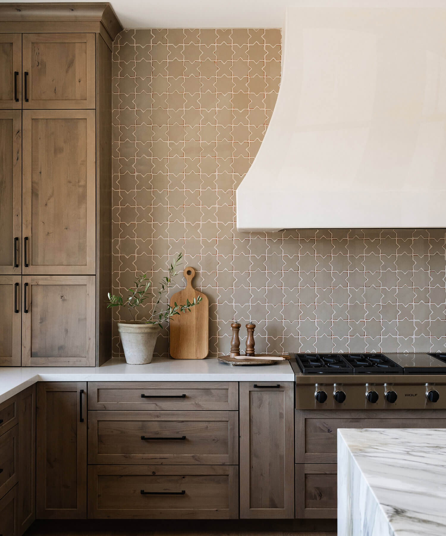 With an emphasis on comfort, heritage-inspired details, and lived-in textures, this family home is a Mediterranean oasis. This stunning Mediterranean inspired home features Dura Supreme’s Hudson shaker door style in a combination of the “Cashew” stain on Knotty Alder