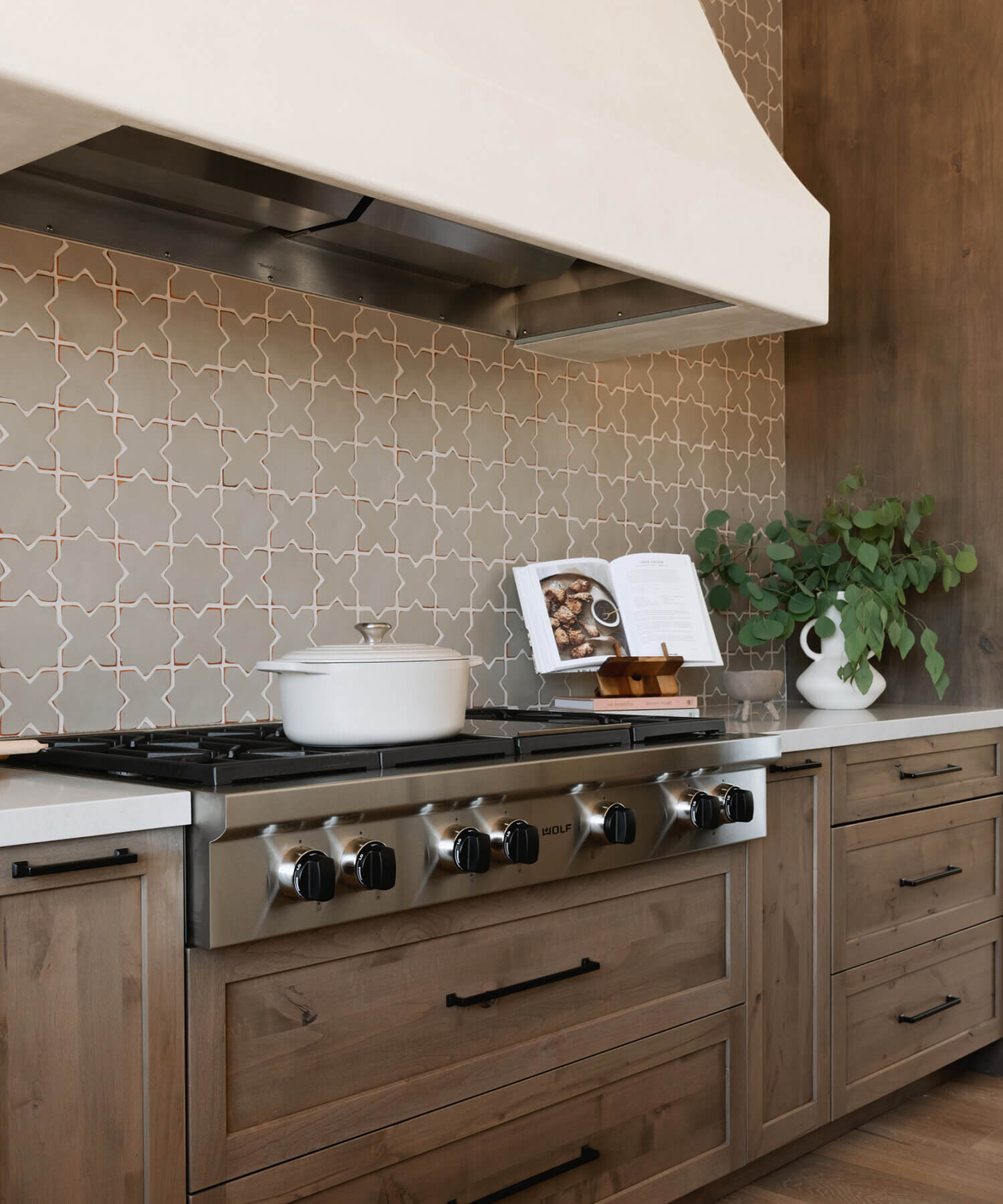 With an emphasis on comfort, heritage-inspired details, and lived-in textures, this family home is a Mediterranean oasis. This stunning Mediterranean inspired home features Dura Supreme’s Hudson shaker door style in a combination of the “Cashew” stain on Knotty Alder