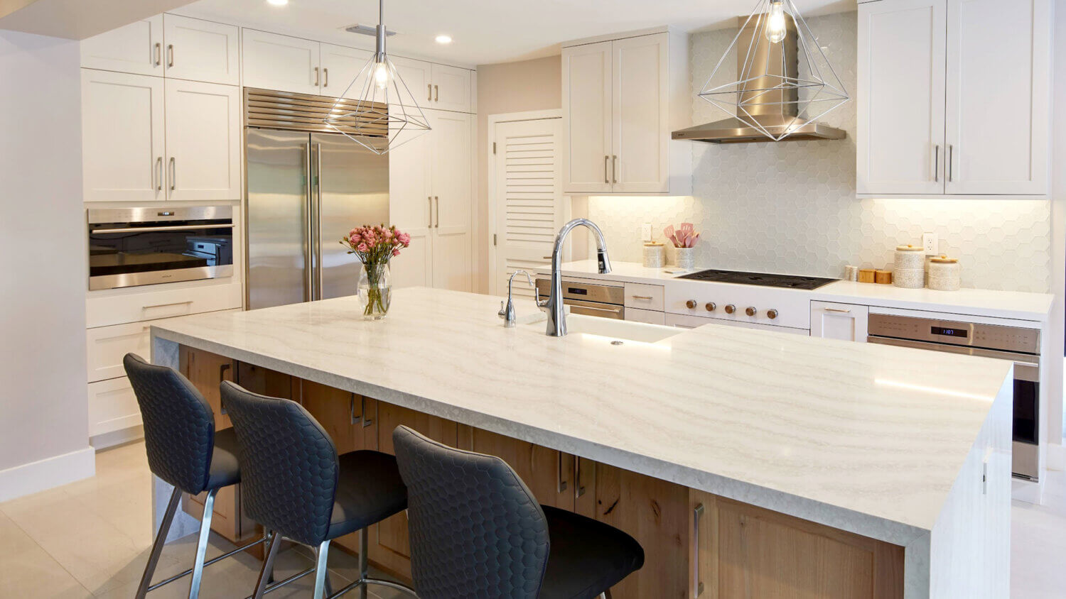 Modern, crisp paint finishes collide with natural, rustic, knotty alder in this transitional style kitchen remodel. The kitchen cabinets use Dura Supreme Cabinetry’s Hudson door style in Knotty Alder with a “Natural” finish for the kitchen island contrasted with the “Dove” paint for the perimeter.