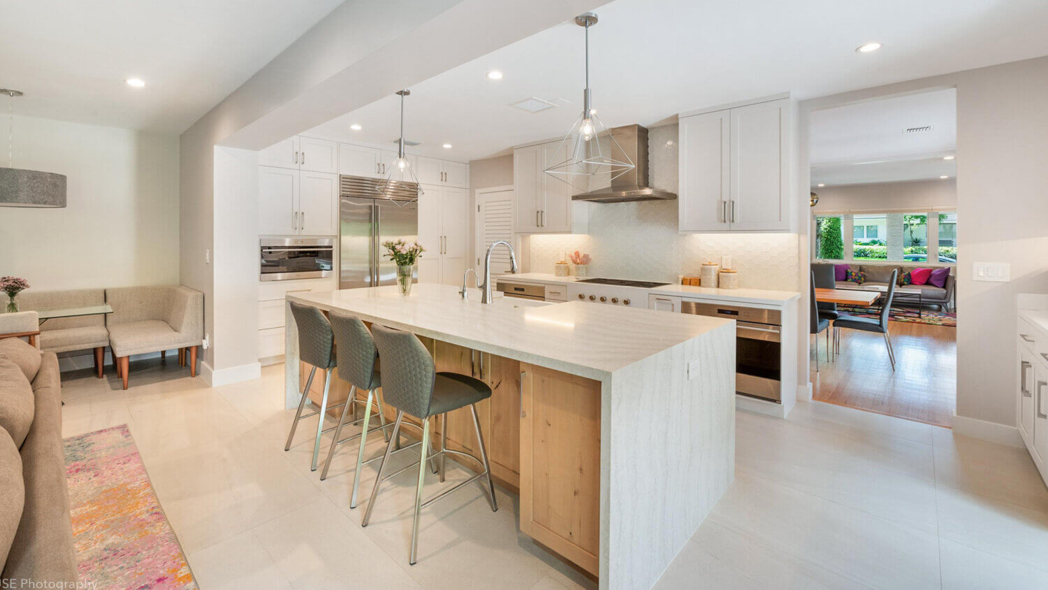 Modern, crisp paint finishes collide with natural, rustic, knotty alder in this transitional style kitchen remodel. The kitchen cabinets use Dura Supreme Cabinetry’s Hudson door style in Knotty Alder with a “Natural” finish for the kitchen island contrasted with the “Dove” paint for the perimeter.