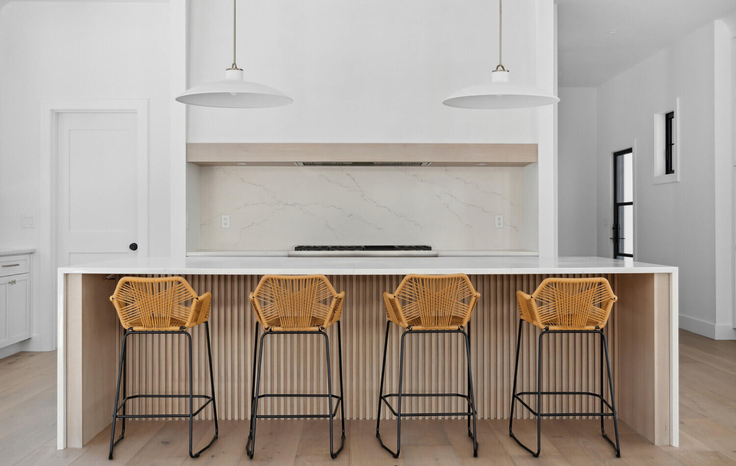 A beautiful ultra-modern farmhouse kitchen with cabinets shown in a white paint and light natural stained quarter-sawn white oak wood.