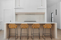 A beautiful ultra-modern farmhouse kitchen with cabinets shown in a white paint and light natural stained quarter-sawn white oak wood.