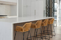 A waterfall kitchen island with seating for 4 featuring light stained oak with custom fluted texture.