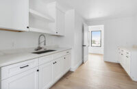 A beautiful all white laundry room design.