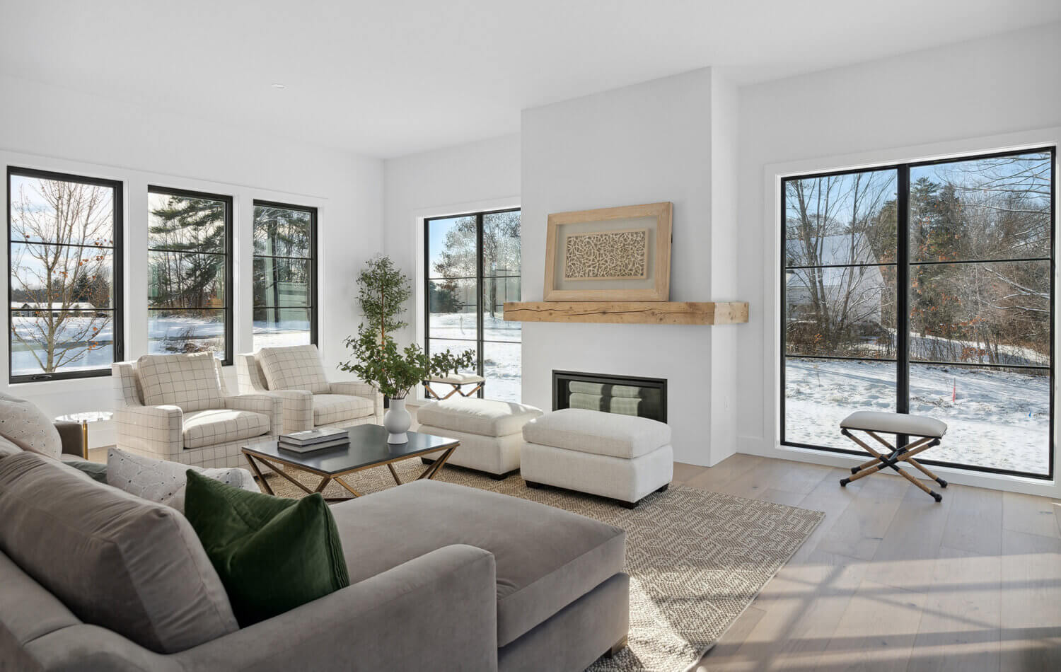 A simple fireplace mantel in a modern farmhouse living room.