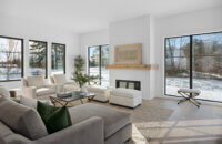 A simple fireplace mantel in a modern farmhouse living room.