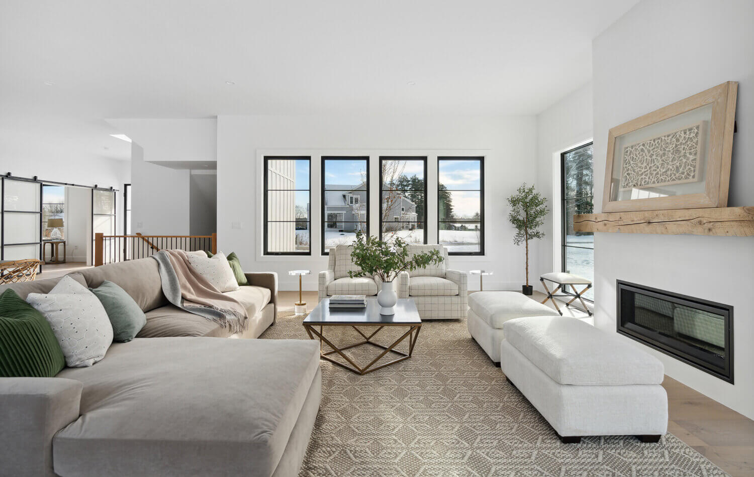 A modern farmhouse living room with cozy decor and seating.