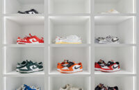 A luxury walk-in closet off the master bedroom with his and her storage. There is a full wall of open cubby storage for displaying shoes with integrated lighting to accent and create a store-like feel to the space.