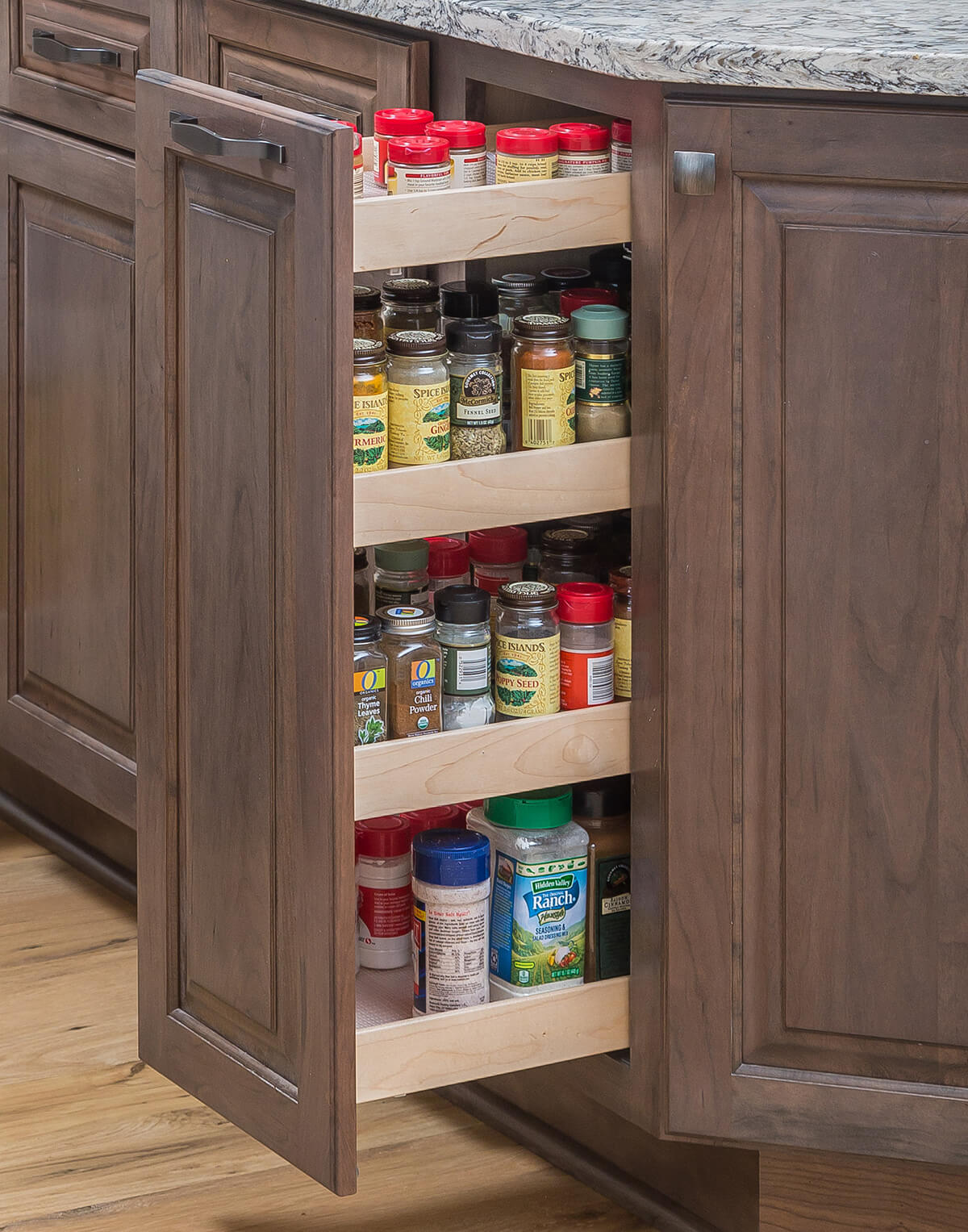 A base height pantry pull-out cabinet that houses lots of pantry supplies for the baking station area for supplies like flour, sugar, vanilla, nutmeg, etc.