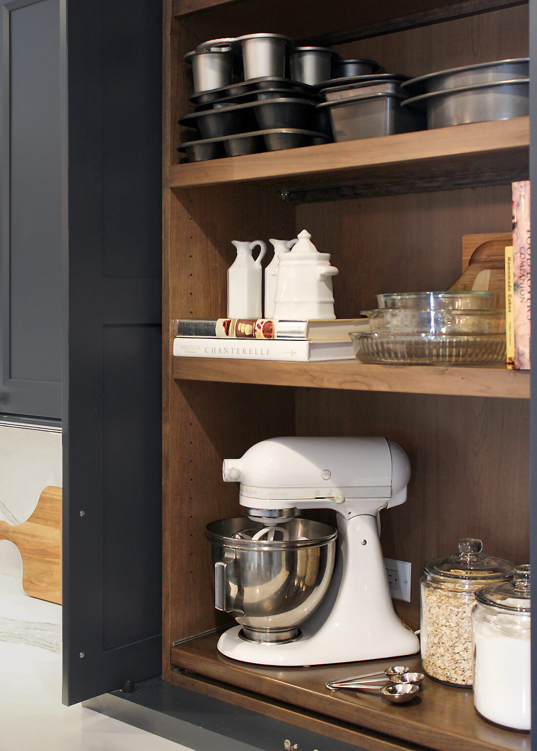 Dura Supreme's Baking Center Larder Cabinets offer thoughtfully planned shelves and cubbies provide dedicated space for an assortment of baking gadgets, pantry goods, and measuring cups, keeping them easy to find and at your fingertips.
