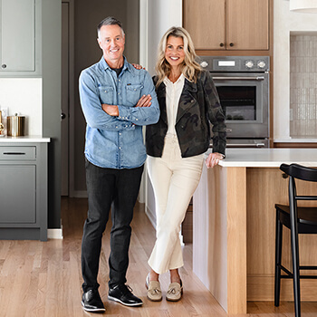 A happy couple in a new kitchen with Dura Supreme Cabinetry.