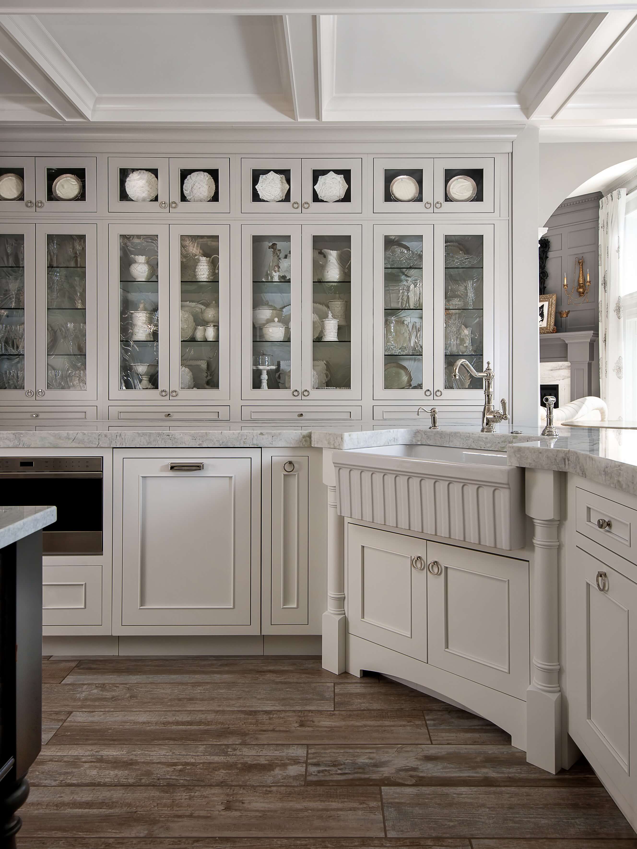 An elegant and traditional kitchen design featuring inset cabinet doors in a white paint color to create a historic flavor to the design.