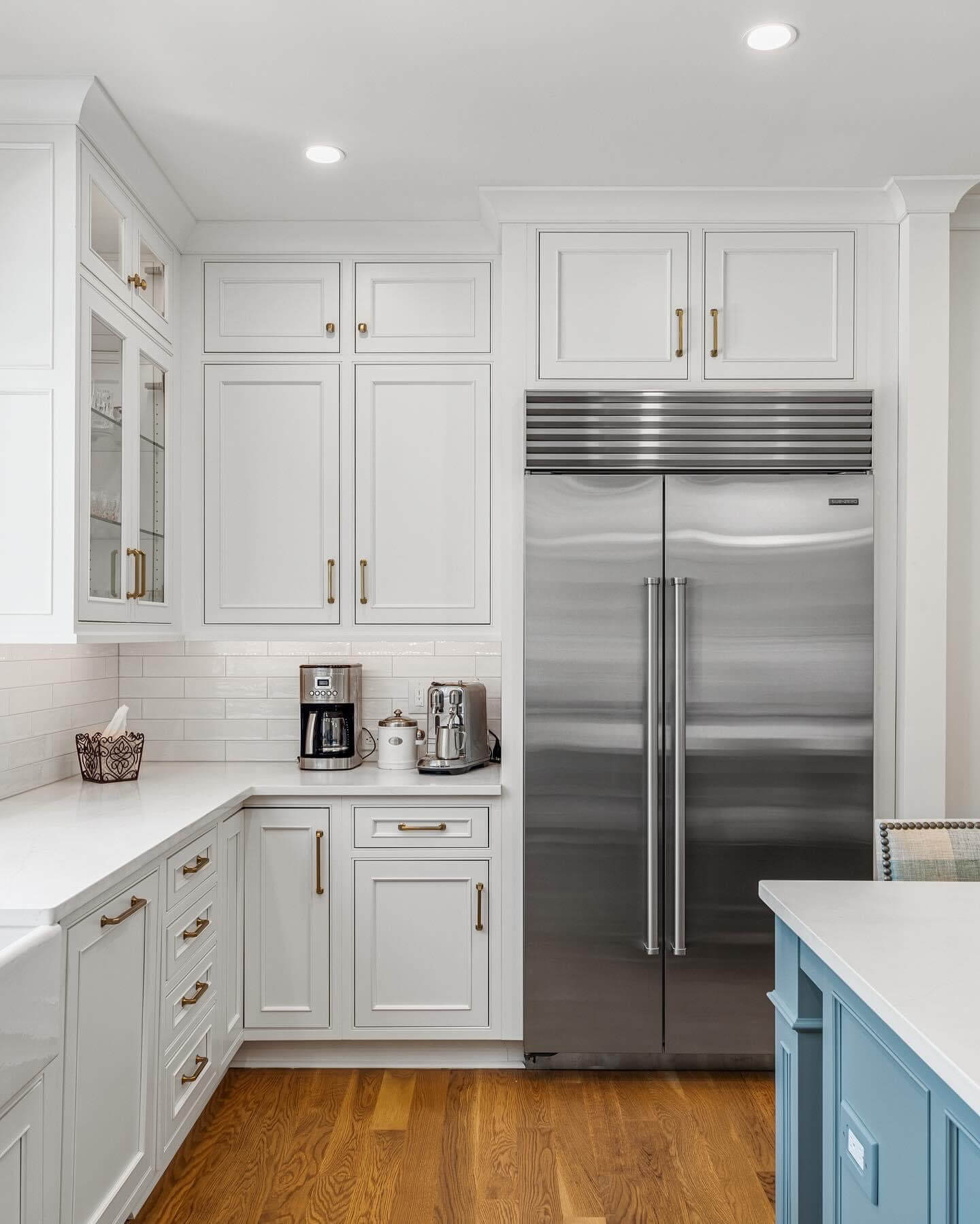 A view of the bright white painted inset cabinets with a classic shaker style.