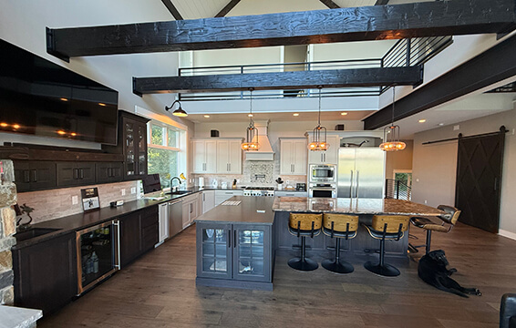 A modern farmhouse kitchen with vaulted ceilings and lots of cabinets.