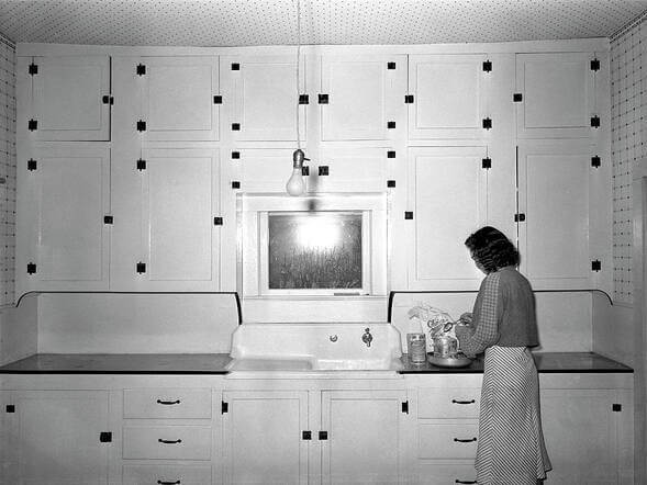 A 1930s kitchen showing the historic look of inset cabinets when they were first introduced as built-in cabinets that filled the kitchen. Many used latches and barrel hinging.