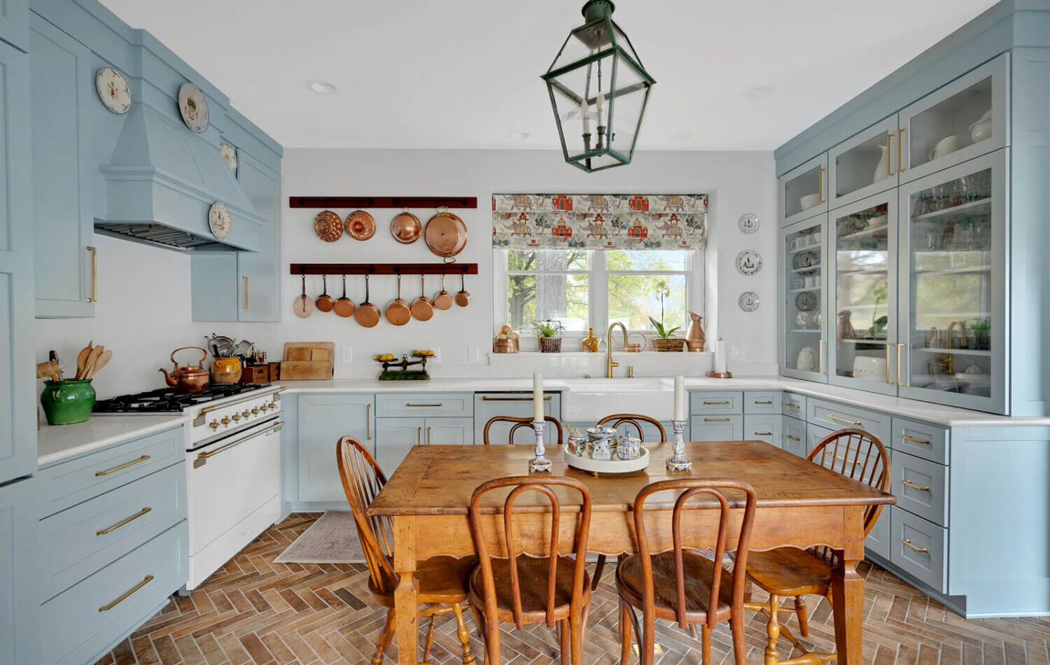 A light, baby blue kitchen design with a classic cottage style.
