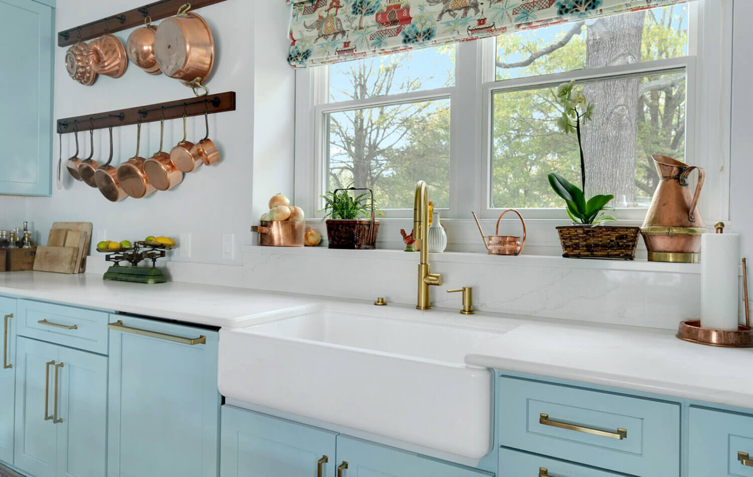 A light, baby blue kitchen design with a classic cottage style.