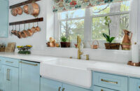 A light, baby blue kitchen design with a classic cottage style.