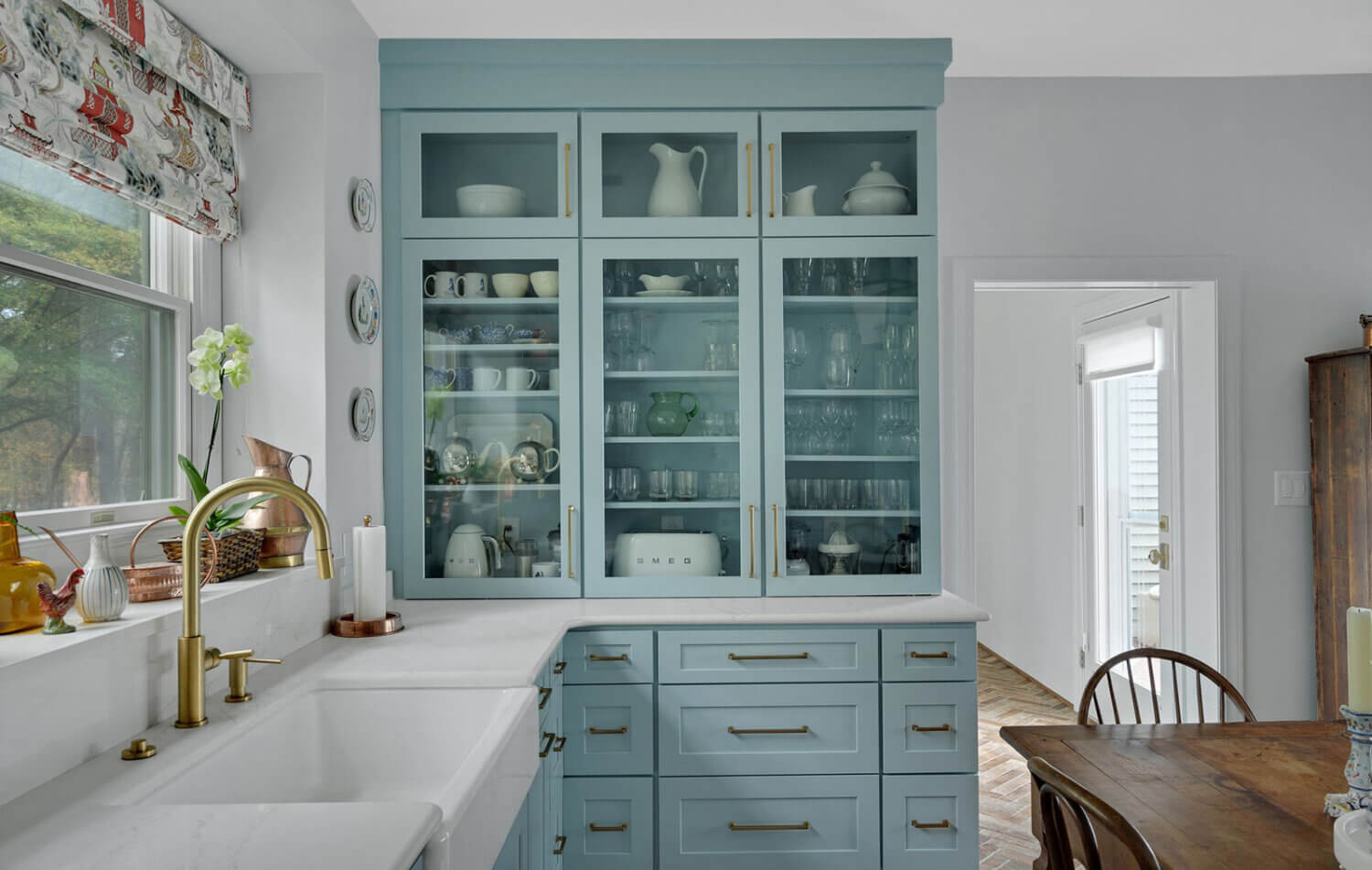 A light, baby blue kitchen design with a classic cottage style.