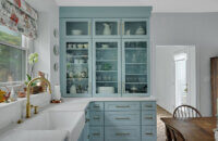 A light, baby blue kitchen design with a classic cottage style.