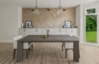 A contemporary dining room with clean lines and skinny shaker cabinets in a natural, off-white paint color.