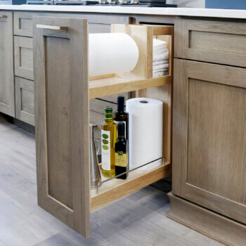 This base cabinet pull-out has built-in paper towel roll storage that fits jumbo sized rolls. with a shelf and compartment for additional storage for cleaning supplies or misc. kitchen supplies like cooking oils.