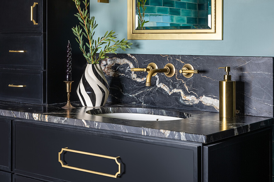 This trend-setting bathroom remodel embraces a black color palette with glimmery gold accents and vibrant emerald green tones.. Black is a color trend that is forecasted to become a mainstream kitchen trend in a few years.